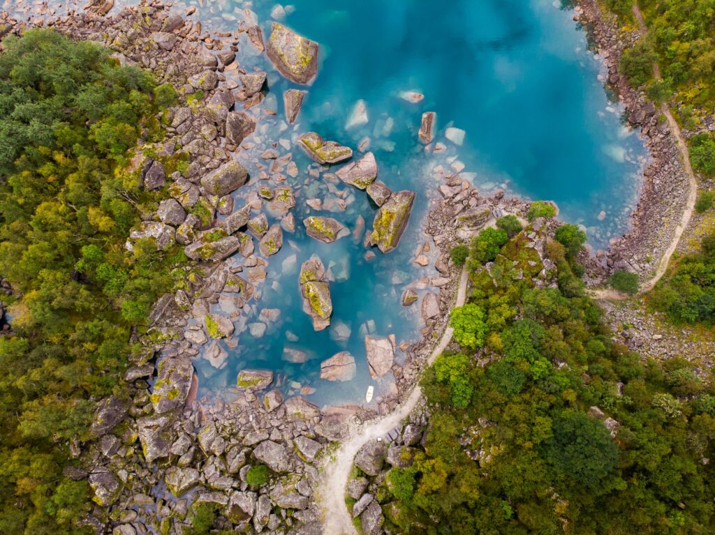 Explore the tranquil beauty of Ænes Lake with crystal-clear waters and lush greenery. Abritel Location Vacances