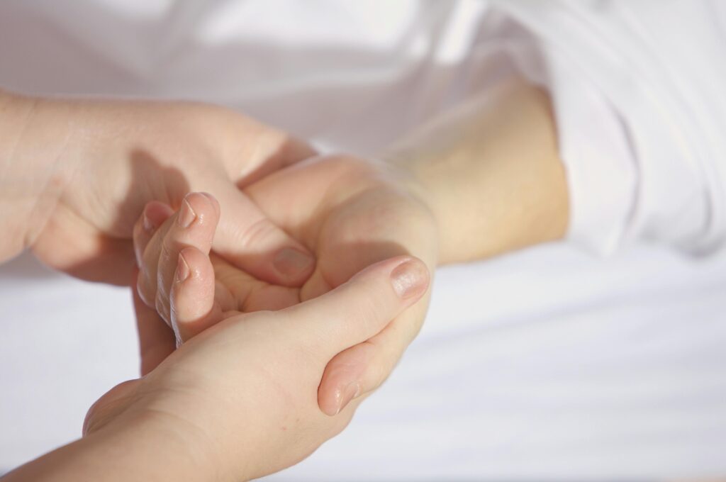 Relaxing hand massage therapy session close-up with gentle touch and care. Motion Energy Body Balm.